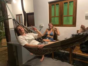 a man and a woman sitting in a hammock at The Woodnest in Arugam Bay +117 photos