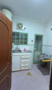 a kitchen with a sink and a clock on the wall at ضيوف الخريف in Salalah