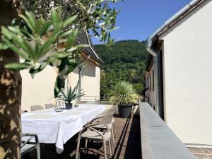 a white table and chairs on the balcony of a house at Luxury Old Town Suite - XXL Terrasse & XXL Penthouse in Heidelberg