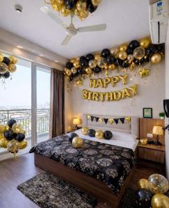a bedroom with a bed with a happy birthday sign on the wall at Home Bliss BnB in Greater Noida