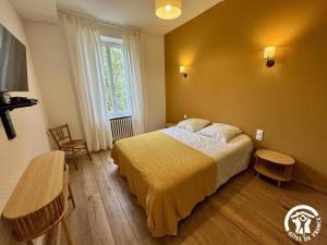 a bedroom with a large bed and a window at La prade in Saint-Ferriol