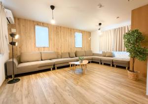 a living room with a couch and a table at Triangle 2nd in Beppu