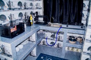 a miniature kitchen with a sink and a counter top at Ray Infinity Suites in Paje