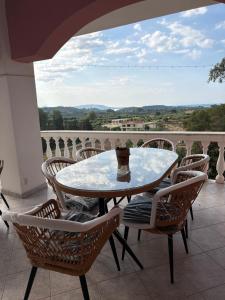 a table and chairs on a balcony with a view at Happyfield in Lixouri