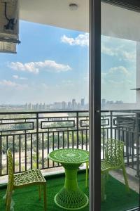 a table and chairs on a balcony with a view at Home Bliss BnB in Greater Noida