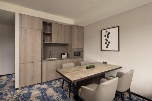 a kitchen and dining room with a table and chairs at Hyatt Place Seoul Pangyo in Seongnam