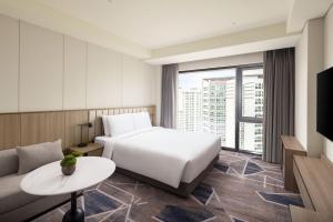 a hotel room with a bed and a couch at Hyatt Place Seoul Pangyo in Seongnam +23 photos