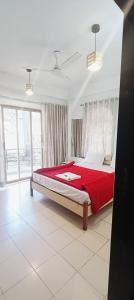 a bedroom with a large bed with a red blanket at Nature Trinity House in Panchgani +14 photos
