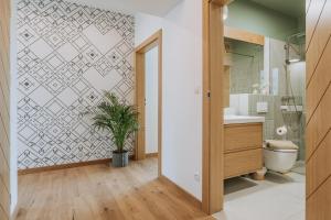 a bathroom with a potted plant next to a toilet at Matygowa Osada in Gliczarów Górny +103 photos