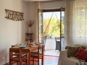 a living room with a table and a couch at ECO - Villa Giulia in Dormelletto