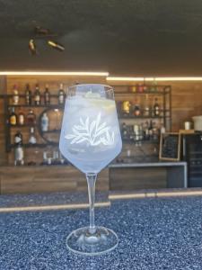 a wine glass sitting on top of a counter at A Flor da Rosa in Vila Nova de Foz Coa