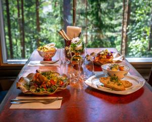 a wooden table with plates of food on it at Sveitsin Maja in Hyvinkää +23 photos