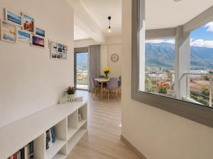 a living room with a large window and a table at Comfy Vista Apartment in Kalamata +64 photos