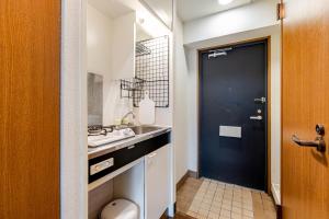 a bathroom with a sink and a toilet and a black door at 大濠ウエストビレッジ209 in Fukuoka +16 photos