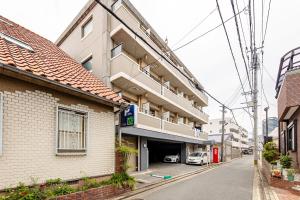 a building with a parking garage on a street at 大濠ウエストビレッジ209 in Fukuoka