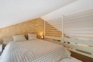 a bedroom with a large bed in a attic at Gite Beauséjour in Gaugeac