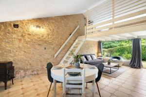 a living room with a couch and a table at Gite Beauséjour in Gaugeac