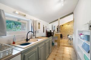 a kitchen with a sink and a window at Gite Beauséjour in Gaugeac +17 photos