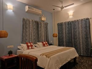 a bedroom with a bed and a ceiling fan at BrightMoon_Homestay in Pondicherry