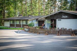 a house with a wooden fence in front of it at Sveitsin Maja in Hyvinkää