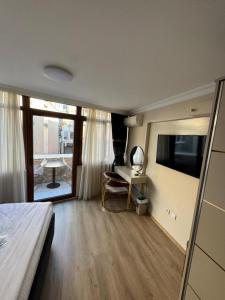 a bedroom with a bed and a television and a desk at New Hotel Harbiye Studio in Istanbul