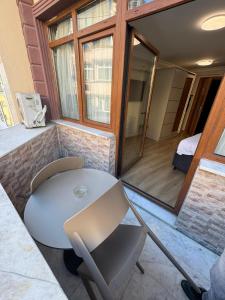a room with a table and chairs and a bed at New Hotel Harbiye Studio in Istanbul