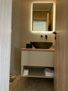 a bathroom with a sink and a mirror at Mu Caza Monemvasia in Monemvasia +35 photos