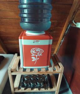 a vase sitting on top of a wooden stand at Cozzy Villa Hajeka in Palayangan