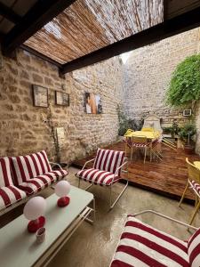 a patio with two couches and a table and a table at Plumard in Arles