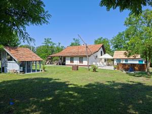 two houses and a yard with a grass field at Naprózsa Tanya in Bugac Felső Vasútállomás