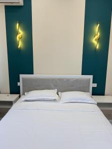 a bedroom with a white bed with two pillows at Улы Дала in Shymkent +3 photos