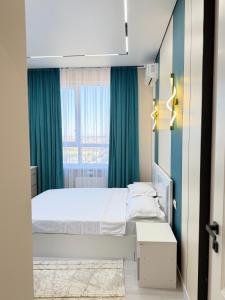 a bedroom with a bed and a window at Улы Дала in Shymkent
