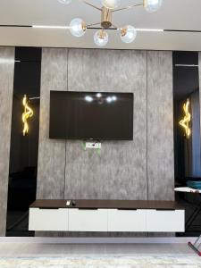 a living room with a flat screen tv on a wall at Улы Дала in Shymkent
