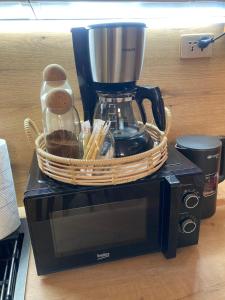 a basket sitting on top of a microwave at Newly Renovated Japandi 1BR Near Shangri-La in Ulaanbaatar +11 photos