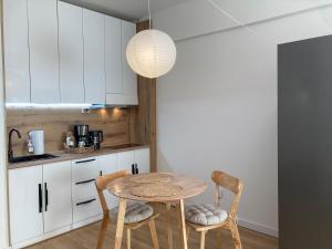 a kitchen with a table and chairs in a room at Newly Renovated Japandi 1BR Near Shangri-La in Ulaanbaatar