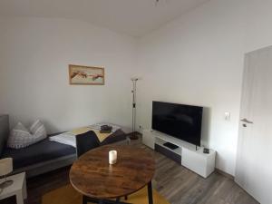 a living room with a couch and a table at NEU! Ferienhaus Schwedt in Schwedt