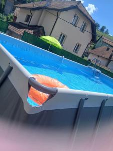 a swimming pool with an orange object in the back at Apartman Dunja in Bajina Bašta