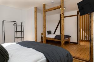 a bedroom with a four poster bed and wooden beams at Gemütliches Ferienhaus in Kell am Traumpfad nahe Maria Laach in Andernach