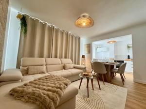 a living room with a couch and a table at Le Cocon Doré in Calais