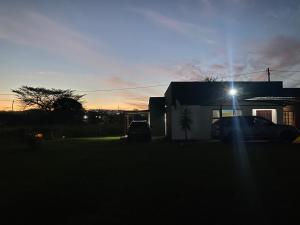 a car parked in front of a house with a light at EeeLSii Health Rest in Manzini