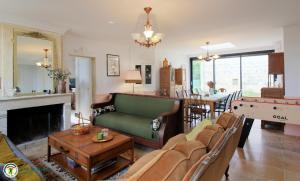 a living room with a couch and a table at la caquetoire in Les Églisottes-et-Chalaures