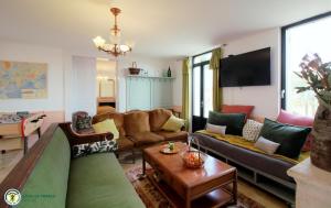 a living room with a couch and a table at la caquetoire in Les Églisottes-et-Chalaures