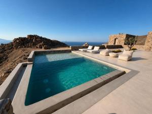 a swimming pool with the ocean in the background at Lucevista Mykonos Villas in Fanari