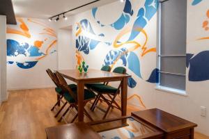 a dining room with a wooden table and chairs at The Aoca Tokyo Sanno in Tokyo