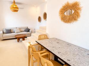 a living room with a table and a couch at Lucevista Mykonos Villas in Fanari