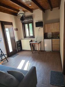 a living room with a couch and a kitchen at Xenonas Orizontes in Dimitsana +37 photos