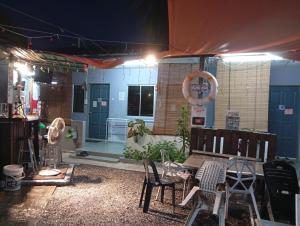 a group of chairs and tables in a room at Langkawi-Village Mix Dormitory in Pantai Cenang