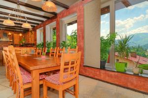a dining room with a wooden table and chairs at Wild House Szczyrk in Szczyrk