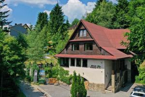 a house with a red roof on a hill at Wild House Szczyrk in Szczyrk