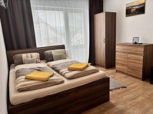 a bedroom with a bed with two pillows on it at Ubytovanie u Albína in Betlanovce